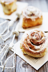 Cinnabon buns. Sinabon rolls with cream cheese and cream, chocolate and almond nuts