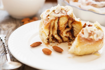 Cinnabon buns. Sinabon rolls with cream cheese and cream, chocolate and almond nuts