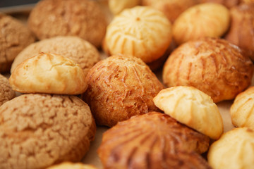 Homemade profiteroles on the music sheet with notes. Profiteroles (choux à la crème) - French choux pastry balls filled with custard or cottage cheese