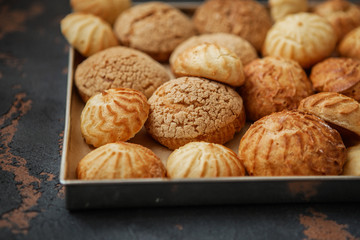 Homemade profiteroles on the music sheet with notes. Profiteroles (choux à la crème) - French choux pastry balls filled with custard or cottage cheese