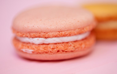 Multicolored macaroons on pink background.