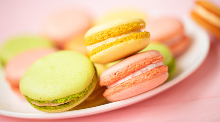 Dessert cake macaron or macaroon on pink background top view. Flat lay composition. 