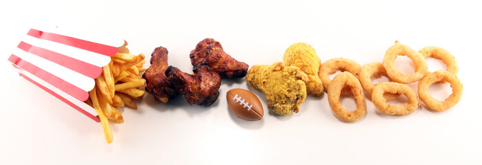 chicken wings, fries and onion rings for football on a table. Great for Bowl Game