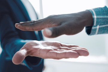 close up.business people holding out their hands for a handshake