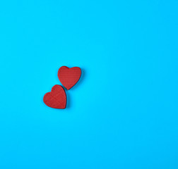 two red wooden hearts on a blue background