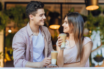 Beautiful couple talking on the terrace of the restaurant