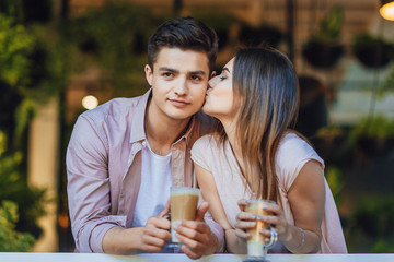 beautiful couple kisses on the summer terrace