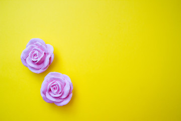 Polymer clay flowers, bright yellow background. Copy space