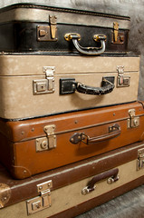 old and damaged suitcases stacked on top of each other