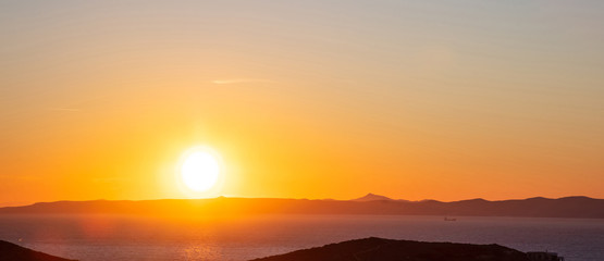Sunset over Attica, clear orange color sky background, Kea island, Greece.