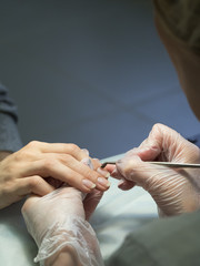 Procedure of processing the cuticle in manicure. 