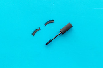 female desk with decorative cosmetic on blue background flatlay copyspace