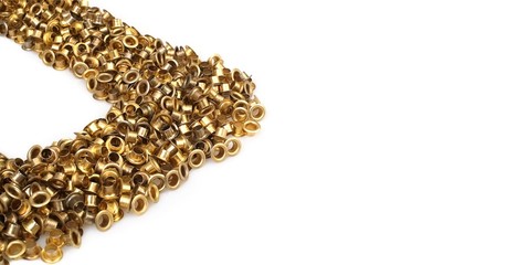 Spilled gold grommets isolated on white background