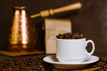 Turkish coffee brewing pot. Cup with coffee beans