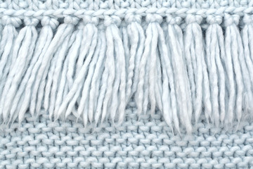 The texture of knitted wool fabric of purl loops with fringe.