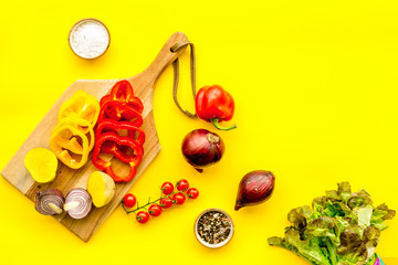 Fresh food ingredients for vegetarian kitchen on yellow background top view mock-up