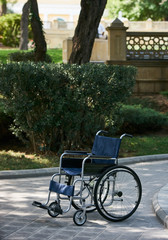 Empty wheelchair at the park, close-up, outdoors. Miracle concept