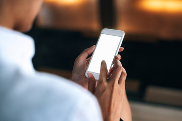 Woman using a smartphone read and text messages with blank space screen display from behind view- woman office worker- digital and communication concept