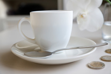 Flat lay financial planning, hand doing calculation with mobile phone and objects on yellow table top.