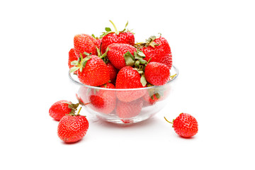 Image of green strawberry in glass cup on empty white background.