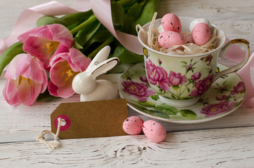 Easter egg and beautiful Tulips on a wooden background. - Image