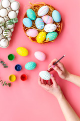 eggs with colorful paint for easter tradition on pink background top view mockup