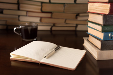 Naklejka premium open notebook and cup on the desktop