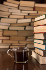 cup and many books on the desktop