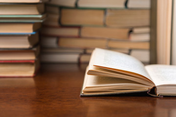 open book on the table against the background of books