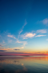 Naklejka na ściany i meble calm sunset with no wind on the lake