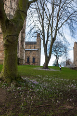 Fototapeta na wymiar A girl runs in the distance playing in the yard of Durham Cathetral, UK