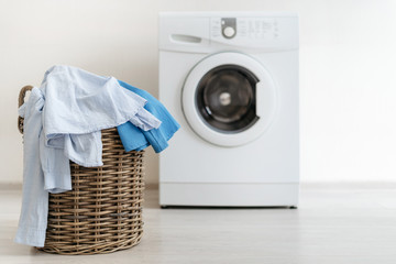 Laundry room interior with washing machine near wall