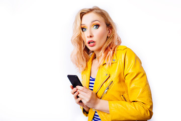 Surprised blonde girl with a smartphone.