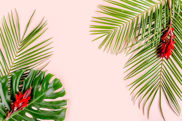Fototapeta na wymiar Tropical palm leaves Monstera on pink background. Flat lay, top view minimal concept.