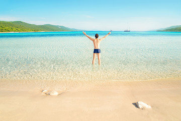 Fototapeta na wymiar happy man standing on tropical beach