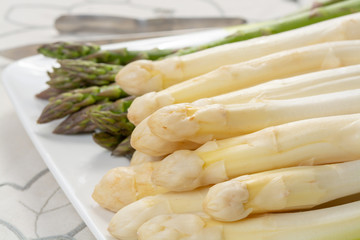 New harvest of white and green asparagus vegetable in spring season, washed asparagus ready to cook, spring menu for restaurants