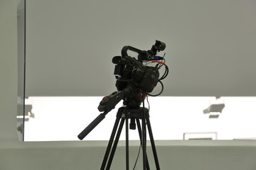 Modern professional HD video camera on a black tripod