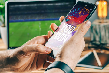 Man celebrating victory after making bets at bookmaker website