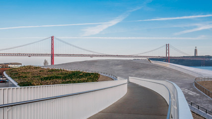 Pedestrian bridge leading to Landmark 25 of April bridge on Tagus River, Lisbon, Portugal