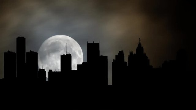 Detroit: View of Cityscape by Night with Full Moon and Clouds in Time Lapse, USA