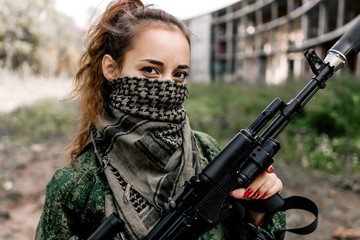 Armed girl with a sniper gun in the women's army