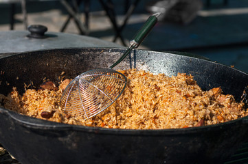 rice with meat, national Uzbek cuisine, national dish of pilaf, street food during the festival