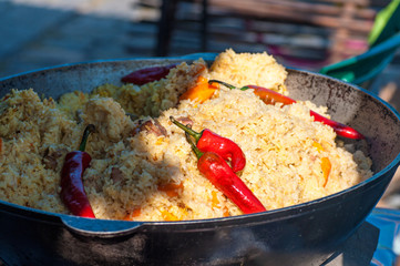rice with meat, national Uzbek cuisine, national dish of pilaf, street food during the festival