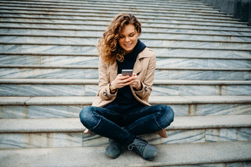 Female smiling and typing text messages