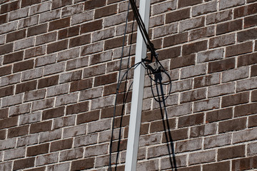 Utility cables attached to brick building