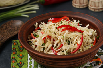 Healthy salad from cabbage and sweet pepper in a brown salad bowl