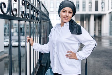 Muslim woman standing on the street in everyday hijab
