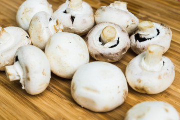 white mushrooms on wooden board