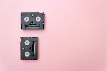 Old mini dv video tapes, retro concept. Video cassette on a pink background, Copy space