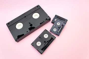 Fototapeta premium VHS and mini dv video tapes cassette on Pink background